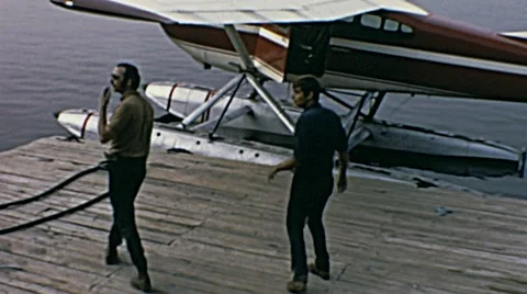 Canada 1970: people jumping into a seaplane Stock Footage