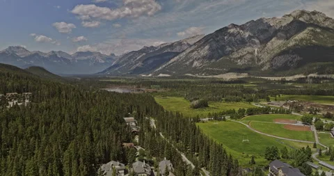 Canada Banff AB Aerial Flyover Forest Valley Residential Stables Stock Footage 338264094