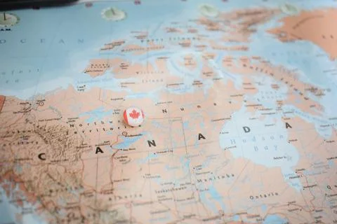 Canada flag drawing pin on the map Stock Photos