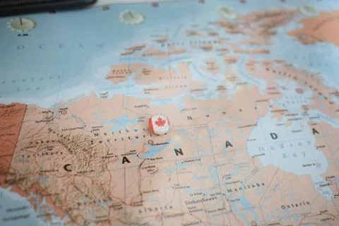 Canada flag drawing pin on the map Stock Photos