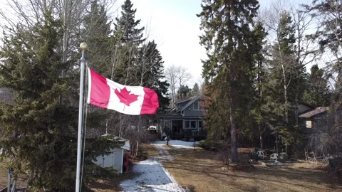 Canada flag in front of winter cottage Stock Footage 151721090