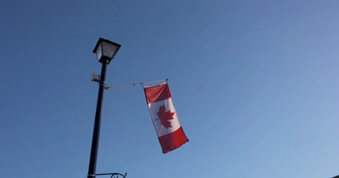 Canada flag waving gently on a lamp post Stock Footage 132387592