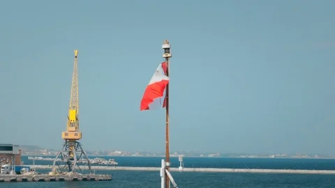 Canada flag waving in the wind. Hanging on the flagpole of a NATO ship moored in 스톡 동영상 119204798