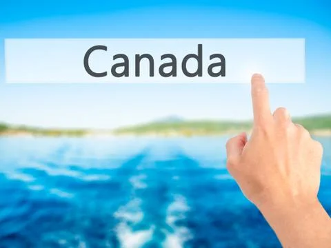 Canada - Hand pressing a button on blurred background concept on visual scree Stock-Fotos