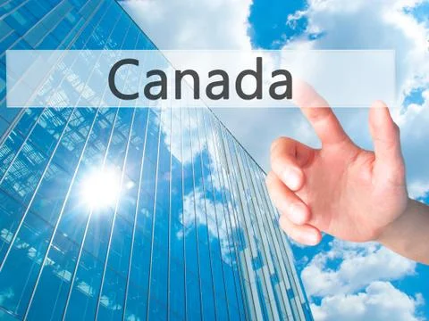 Canada - Hand pressing a button on blurred background concept on visual scree Stock Photos