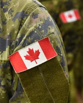 Canada patch flag on soldiers arm Stock Photos