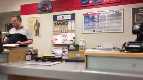 Canada Post Employee Processing Mail at Public Service Counter Stock Footage 334496002