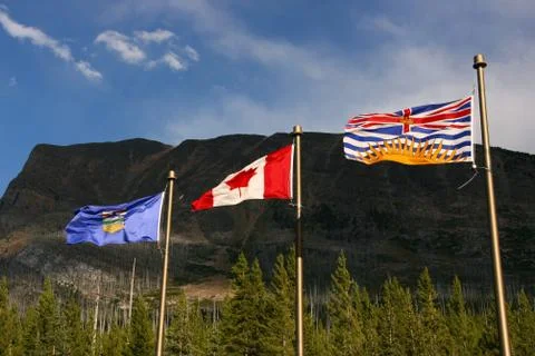 Canada province border - flags of Alberta, Canada and British Columbia. Stock Photos