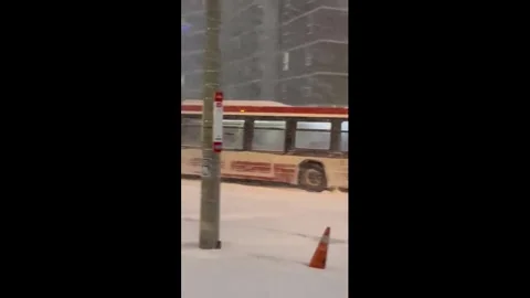 Canada: TTC bus struggles through heavy snow during record storm in Toron... Stock Footage 327689120