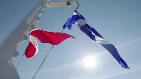Canadian and Quebec Flags Fluttering on a Boat in Tadoussac Stock-Footage 324690414