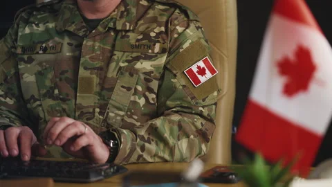 Canadian army officer working on computer in military hub, planning mission Stock Footage 335537518