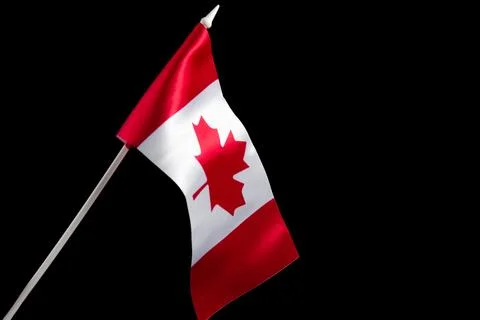 The Canadian flag on a black background developing and waving in the wind Stock Photos
