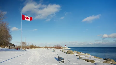 The Canadian flag flutters in the wind after the snow. Video stock 329201548