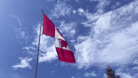 Canadian flag on running clouds sky background Stock Footage 252339171
