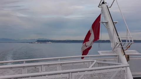 Canadian maple leaf flag onFerry Departing Terminal in British Columbia Stock Footage 326175497