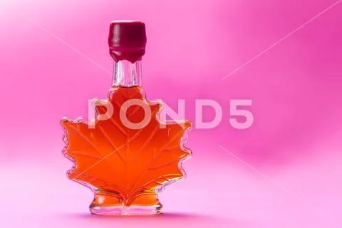 Canadian maple syrup in maple leaf shaped glass bottle Stock Photos