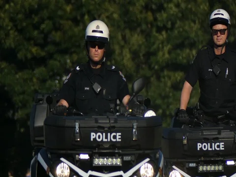 Canadian police officer on duty atv Stock Footage
