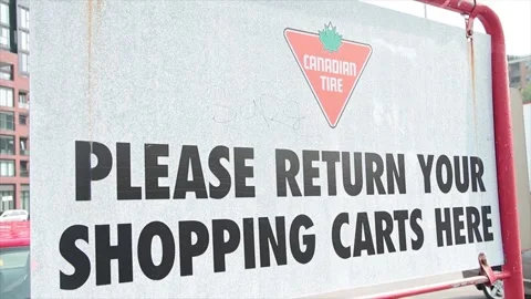 Canadian tire please return your shopping carts here metal sign outside outdoors Stock Footage 248713255