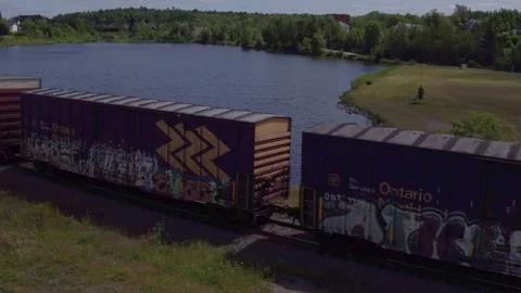 Canadian train passing through town Stock Footage 79195298