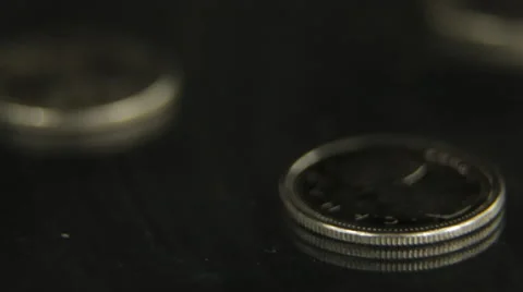 Canadians coins on reflective table Stock Footage 46909445