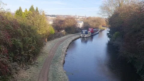 A canal with a boat and path going alongside Stock Footage 258300797