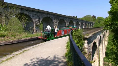 Canal boat being passed by a train on the Llangollen canal Stock-Footage 11132889