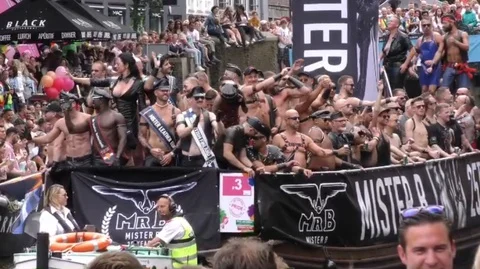 Canal Pride Float with partying leathermen Stock Footage 128397146