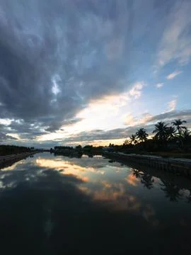 Canal Reflecting Dramatic Sunset Sky Stock Photos