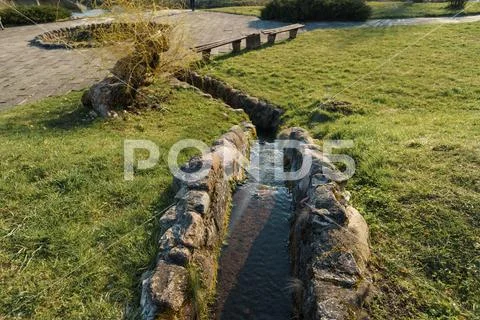 Canal with spring water in city Sabile in Latvia Stock Photos