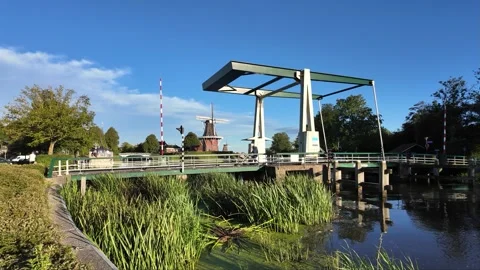 Canal at Sunset with Windmill and Lifting Bridge Stock Footage 304242708