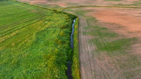 Canal with water in the field. Small river or stream through farmland. Stockbeeldmateriaal 201341155