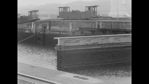 CANAL ZONE, PANAMA - 1953: Lock alignment - Steel gates open below long track Stock Footage 344498357