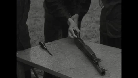 CANAL ZONE, PANAMA - 1962: Weapons maintenance - Hands lift a shotgun tube Stock Footage 344005141