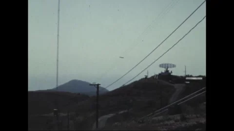 CANAL ZONE, PANAMA - 1969: Comms site - A dish atop a far hazy hill Vídeos de archivo 343936543