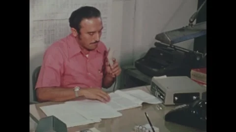 CANAL ZONE, PANAMA - 1972: Interview - A reel machine sits by a bound book Stock Footage 343939195