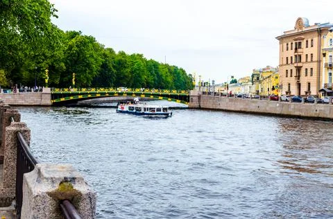 Canals of the Neva river with ship and bridge Stock Photos