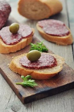 Canape with salami Stock Photos