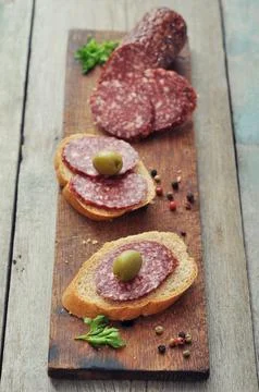 Canape with salami Stock Photos