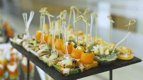 Canapes with salmon and eel on white picks on black serving plate Stock Footage 314458373