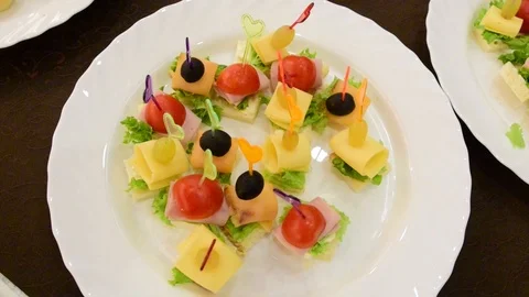 Canapes on white plates on the table during a party Stock Footage 98793538