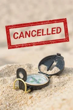 Cancelled stamp on a picture with a compass in a beach sand Stock Photos