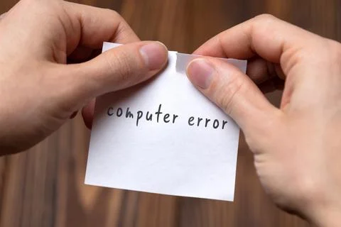Cancelling computer error. Hands tearing of a paper with handwritten inscript 写真素材