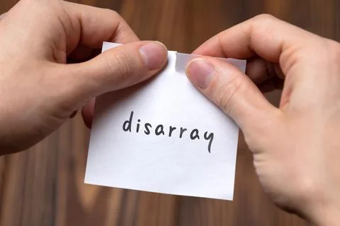 Cancelling disarray. Hands tearing of a paper with handwritten inscription. Stock Photos