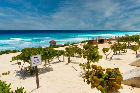 CANCUN, MEXICO - APR 2022: Sandy beach with azure water on a sunny day near C Stock Photos