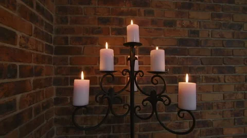 Candelabra set against a dark brick wall Stock Footage 186997374