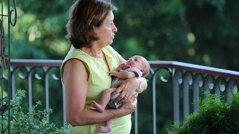 Candid grand-mother holding baby grand-s... | Stock Video | Pond5