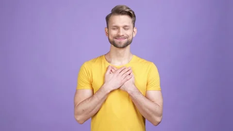 Candid guy put hands heart feel thanks isolated vivid color background Stock Footage 169646625