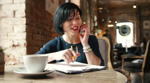 Candid image of a businesswoman working in a cafe. Stock Footage