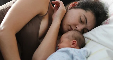 newborn baby sleeping with mom