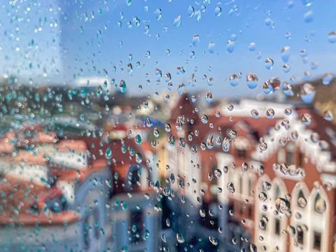 A candid, naturalistic view of a cityscape through a rain-spattered window Stock Photos